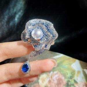 Enchanted Bloom blue rose brooch featuring an 8mm freshwater pearl and blue and clear cubic zirconia